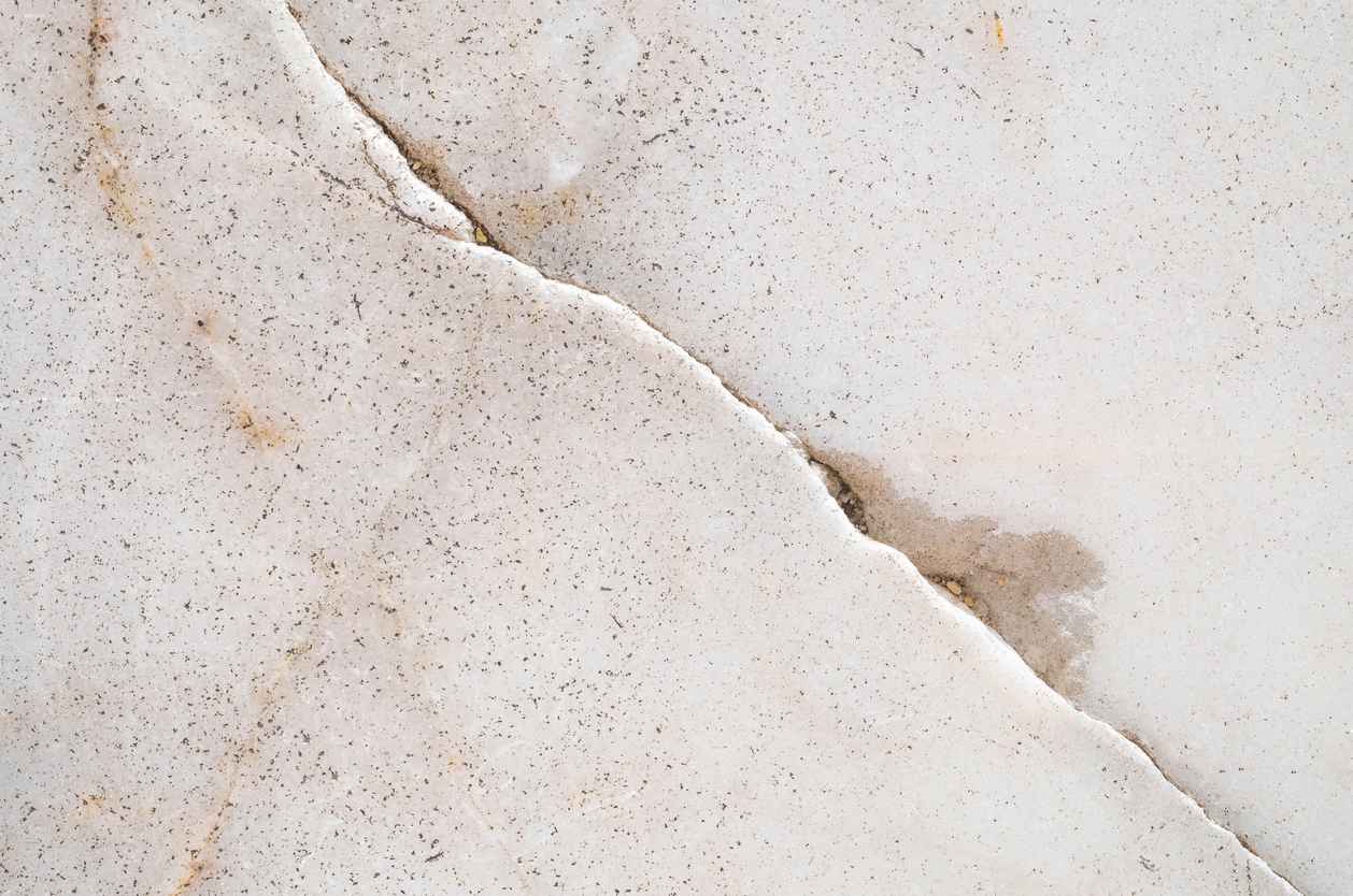 A crack in a home's foundation indicating a slab leak