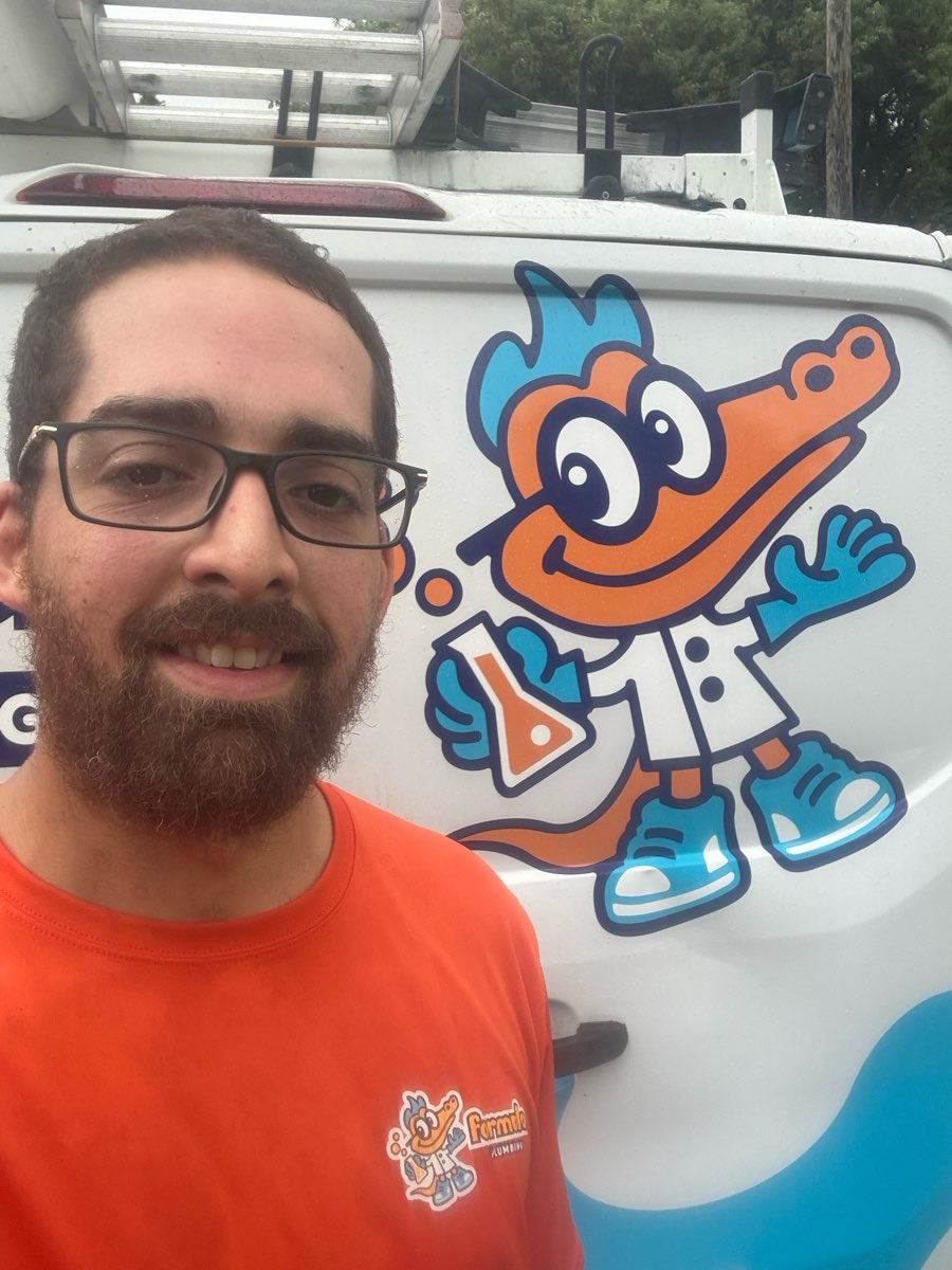 Formula Plumbing employee portrait with company logo in Tampa Bay
