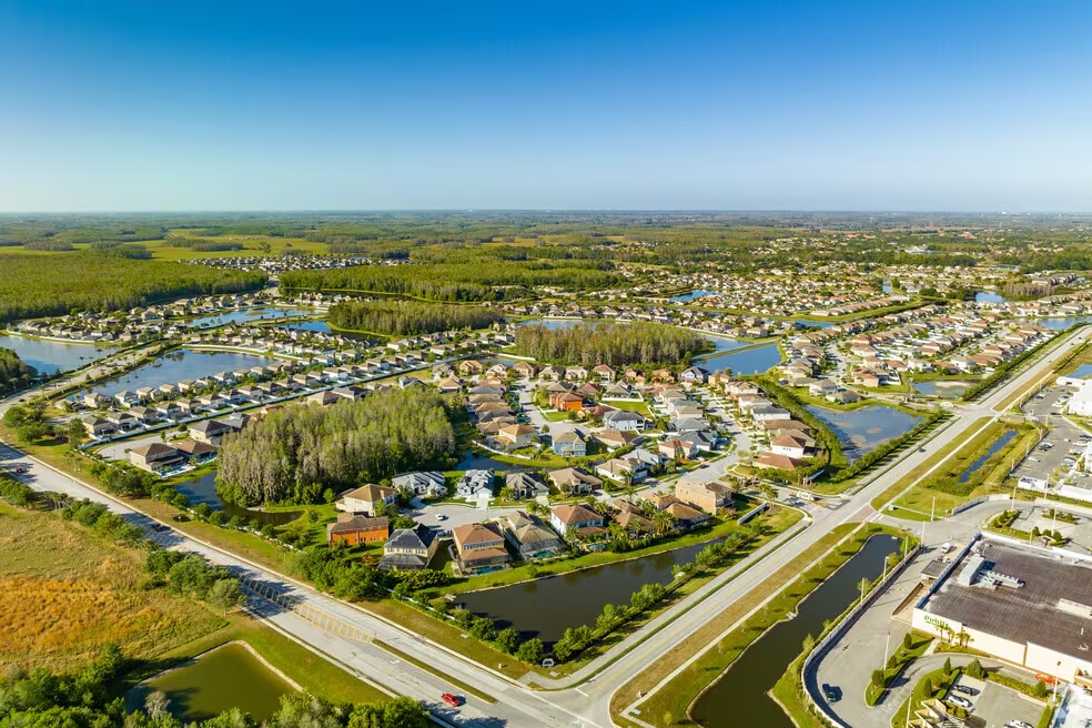 Aerial view of a Trinity, Florida neighborhood with retention ponds, tree-lined streets, and homes served by Formula Plumbing